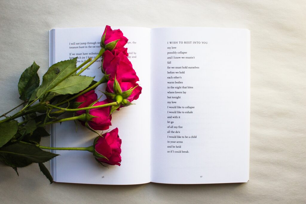 red roses on book with a poem