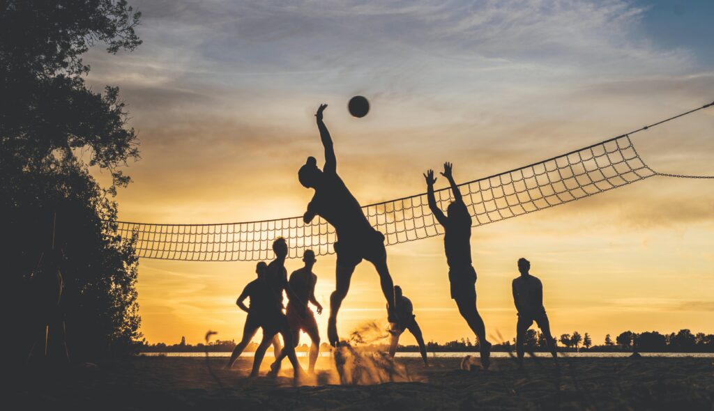 volley ball players in the sunset